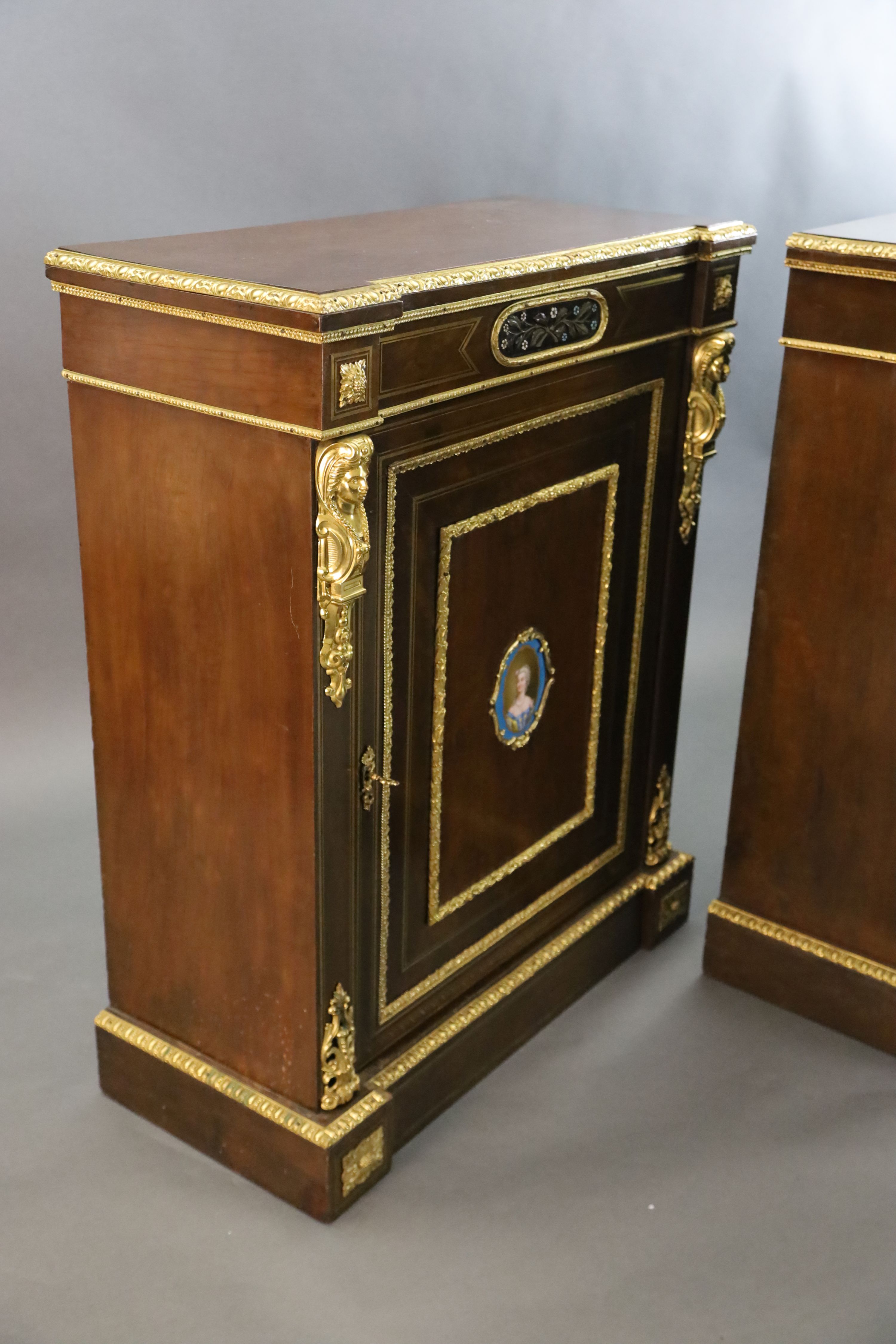 A pair of 19th century French ormolu mounted walnut pier cabinets, W.2ft 11in. D.1ft 4in. H.3ft 7in.